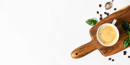 Bunner with Cup of coffee on a wooden cutting board, flat lay, top view, copy spaceの写真素材