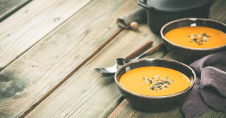 Pumpkin soup on wooden table, copy spaceの写真素材