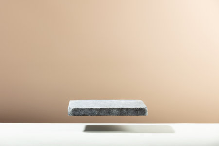 Flying Stone podium for packaging and cosmetic presentation. Monochrome beige template for mockupの写真素材