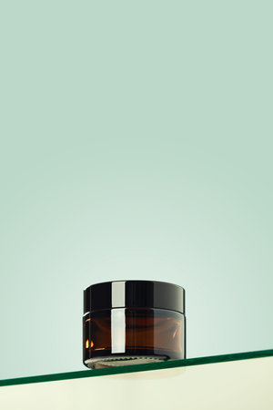 Cometic glass jar for cream on glass shelf green background. Skincare products , natural cosmetic. Beauty concept for face and body care, low angle viewの写真素材