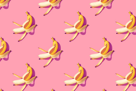 Yellow ripe bananas on pink background pattern