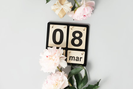 Beautiful pink peony flowers and calendar on white background