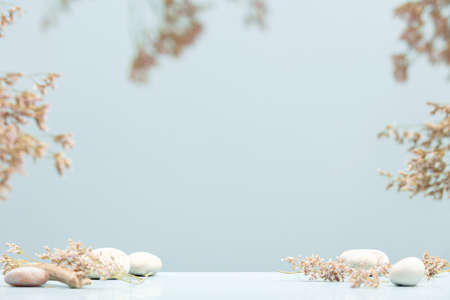 Background for cosmetic products with dry flowers and natural stones. Front viewの写真素材