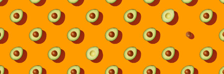 Avocado on orange background pattern top view flat lay