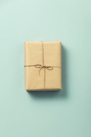 Natural color gift box on blue background, eco friendly trendy zero waste packaging flat lay top viewの写真素材