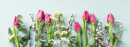 Beautiful composition spring flowers. Bouquet of pink tulips flowers, eucalyptus, spring willow on...