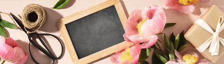 vintage chalk board and spring peony flowers top viewの写真素材