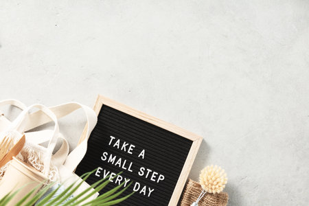 Take a small step every day letter board and zero waste no plastic accessories on grey stone backgroundの写真素材