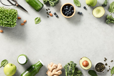 Vegetarian vegan healthy ingredients and green smoothie on grey stone backgroundの写真素材
