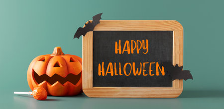 Halloween decorations, bats, pumpkins, chalkboard on blue background. Halloween party posterの写真素材