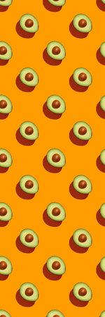 Avocado on orange background pattern top view flat lay. Summer color. Minimal concept