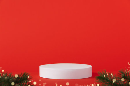 Cosmetic background for Christmas and winter holiday. White podium and christmas decorations on red background.の写真素材
