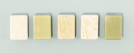 Sustainable lifestyle concept. Bars of natural handmade soap on blue background, top view bannerの写真素材