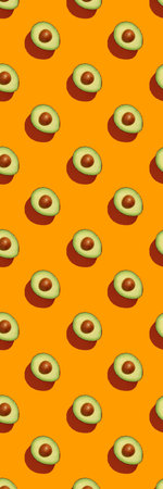 Avocado on orange background pattern top view flat lay. Summer color. Minimal conceptの写真素材