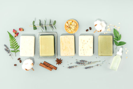 Sustainable lifestyle concept. Bars of natural handmade soap and ingredients on blue background, top view bannerの写真素材