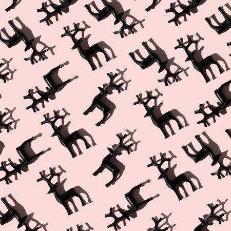 Pattern of black deers on pink background, minimalistic Christmas conceptの写真素材
