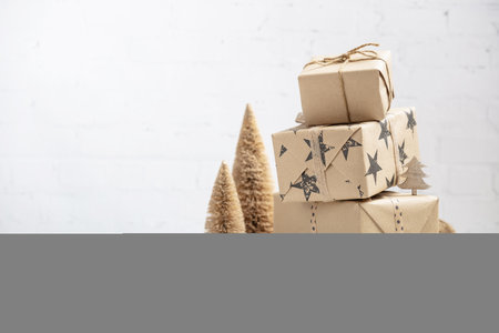 Gift boxes in craft paper, creative and zero waste gift wrapping, copy spaceの写真素材