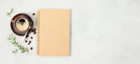 Cup of coffee and notepad on concrete backgroundの写真素材