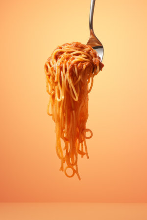 Delicious spaghetti served on a black plate, colorful background, italian food conceptの素材