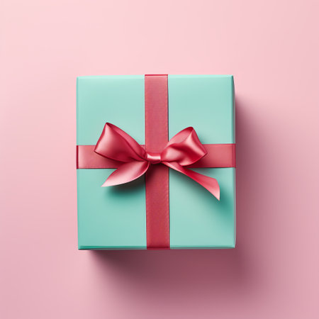 Top view of a mint green present tied with a soft pink satin bowの素材