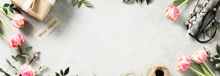 spring flowers, eggs, feathers, gift boxes on light grey backgroundの写真素材