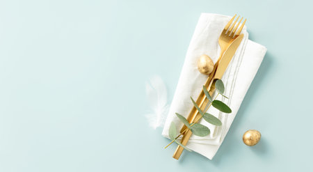 Stylish Easter brunch table setting with eggs and golden cutleryの写真素材