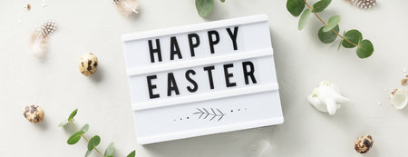 lightbox text Happy Easter and eucalyptus branches on light grey backgroundの写真素材