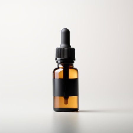 Reusable dark amber glass bottle for oil, cream, lotion or serum on a minimalistic background with shadows and plants. Presentation of a cosmetic product. Layout of the beauty salon branding.の素材