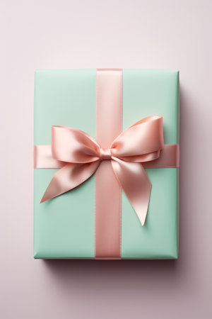 Top view of a mint green present tied with a soft pink satin bowの素材