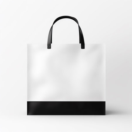 Minimalist white shopping bag with a bold black base and handles, set against a clean, neutral background.の素材