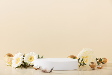 Empty round podium, easter gold eggs with spring flowers on a yellow backgroundの写真素材