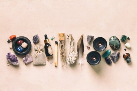 Flat lay of crystals, herbs, and candles arranged for alternative healing and wellness practices, on a light background.の写真素材