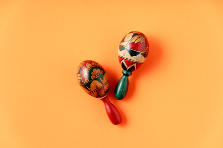 Couple of maracas on vibrant yellow background top viewの写真素材