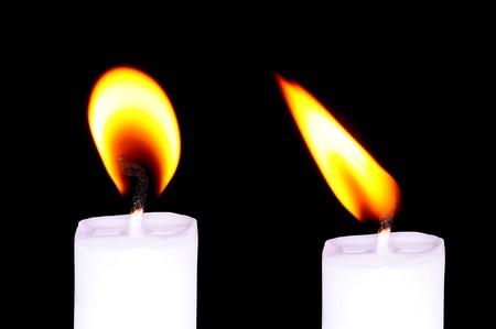 Flaming candle in darknessの写真素材