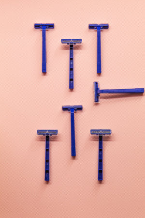 The vertical photo shows a one-time blue razor with a plastic transparent lid. Shaving machines to...