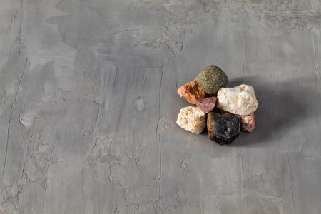 In the picture are stones, which were collected by a man near the river. There are a small number of...