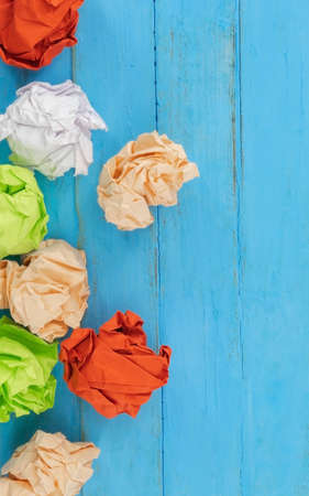 View from above of the crumpled colored dense paper that lies on the tableの写真素材