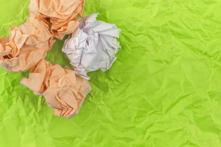 On a salad dented sheet of paper are four heavily crumpled sheets of paperの写真素材