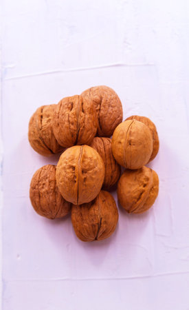 In the center on a white wooden background are walnuts