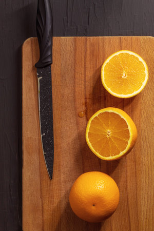 The vertical photo has a black background with a wooden Board for cutting up food. On it lies a...