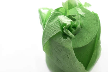 Slightly battered toilet paper soft green color stands on a white backgroundの写真素材