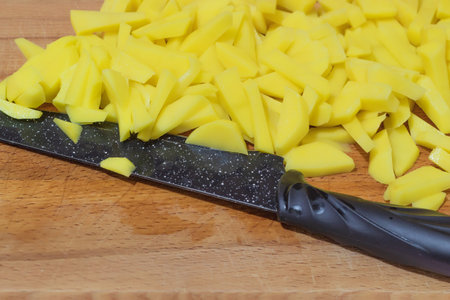 A photo with a pink background shows food. These are raw potatoes, cut into small pieces. The food...