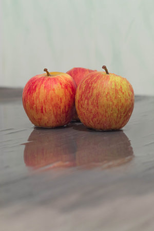 The photo shows a picture of food. These are fresh red apples in the amount of three pieces. Ripe,...