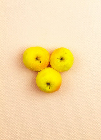 The photo shows the image of raw apple fruits. Here in the center are ripe apples from the home...