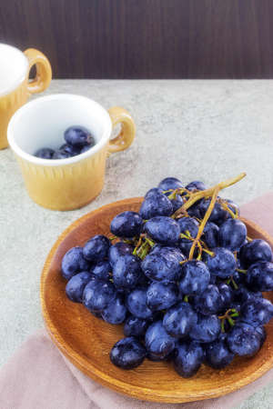 The photo shows a picture of ripe and juicy food. This is a dark grape with seeds. A vine with large delicious berriesの写真素材