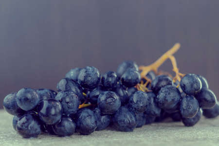 The photo shows a picture of ripe and juicy food. This is a dark grape with seeds. A vine with large delicious berriesの写真素材