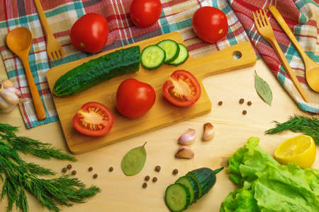 Fresh vegetables, herbs and spices are on the kitchen tableの写真素材