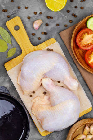 Top view of raw chicken meat lying on a bamboo boardの写真素材