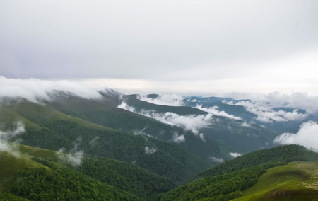 The mist rises between the crevices of the Carpathian Mountainsの写真素材