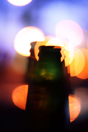 Bottle with multiple shapes and lights in backgroundの写真素材